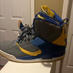 Gray and Yellow High-Top Nike air Jordan’s flight Sneakers.